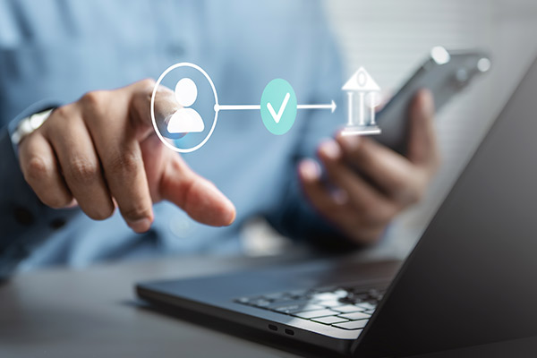 A man working on a laptop with social media icons, exploring high-yield savings accounts and CDs.