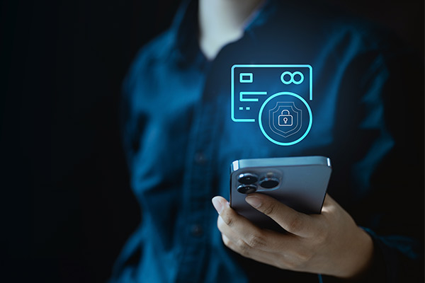 A person holds a smartphone displaying a credit card icon, symbolizing strategies for building credit fast